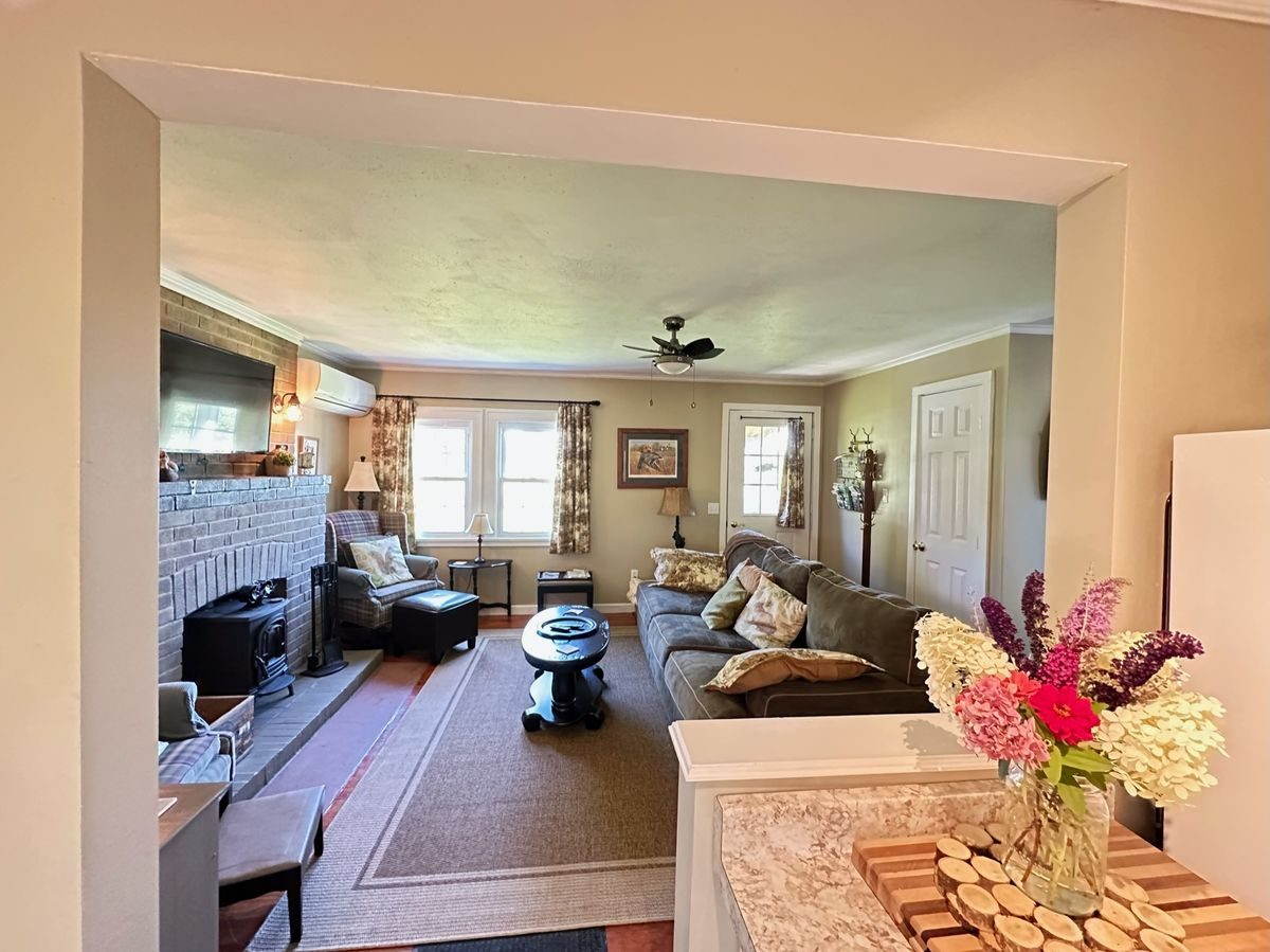 Cozy living room with hardwood floors and wood stove